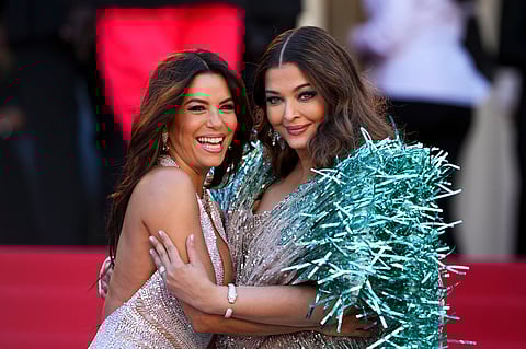 Eva Longoria, left, and Aishwarya Rai Bachchan pose for photographers at Cannes 2024.