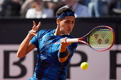 Alejandro Tabilo returns the ball to Djokovic