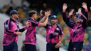 (AP Photo/Ricardo Mazalan) : Scotland's Brad Currie, second from left, is congratulated by teammates after bowling out Namibia's Jan Frylinck for 12 runs during an ICC Men's T20 World Cup cricket match at Kensington Oval in Bridgetown, Barbados, Thursday, June 6, 2024.