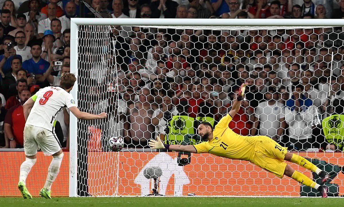 FILE - England's Harry Kane left, shoots to score past Italy's goalkeeper Gianluigi Donnarumma during penalty shootout of the Euro 2020 soccer championship final match between England and Italy at Wembley Stadium in London, Sunday, July 11, 2021. The penalty shootout is a tense battle of wills over 12 yards (11 meters) that has increasingly become a huge part of soccer and an unavoidable feature of the knockout stage in the biggest competitions.  - (Paul Ellis/Pool via AP, File)