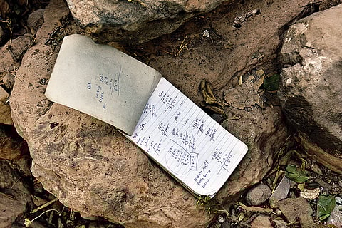 A notebook with scribbles by an unknown person found at the site