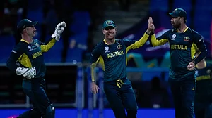 AP Photo/Ricardo Mazalan : Australia's Glenn Maxwell, right, celebrates with teammates David Warner and wicketkeeper Matthew Wade after taking the catch to dismiss Namibia's Michael Van Lingen for 10 runs during an ICC Men's T20 World Cup cricket match at Sir Vivian Richards Stadium in North Sound, Antigua and Barbuda.