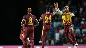 Photo: AP/Ramon Espinosa : Gudakesh Motie (centre) celebrates with teammates after dismissing Kane Williamson during the West Indies vs New Zealand, ICC T20 World Cup 2024 match in Trinidad on June 13.