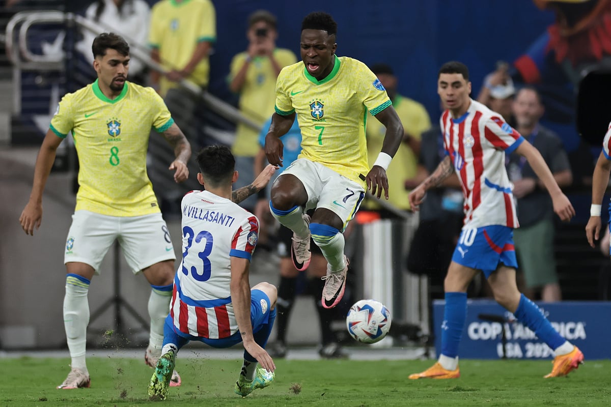 Brazil's Vinicius Junior, center, is tackled by Paraguay's Mathias Villasanti (23), during a Copa America Group D soccer match in Las Vegas, Friday, June 28, 2024. (AP Photo/L.E. Baskow)


 - L.E. Baskow