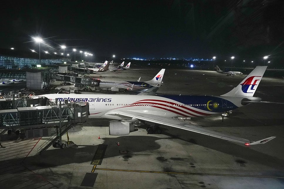 AP Photo/Vincent Thian : A Malaysia airlines plane parked at Kuala Lumpur International Airport in Sepang, Malaysia, Monday, June 24, 2024. Malaysia Airlines says one of its plane en route to Bangkok made a U-turn back to Kuala Lumpur International Airport after experiencing a “pressurization issue.” 