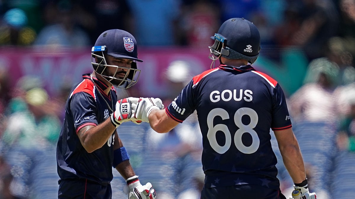AP Photo/Tony Gutierrez : United States captain Monank Patel, left, celebrates scoring runs with batting partner Andries Gous during the ICC Men's T20 World Cup cricket match between the United States and Pakistan at the Grand Prairie Stadium in Grand Prairie, Texas.