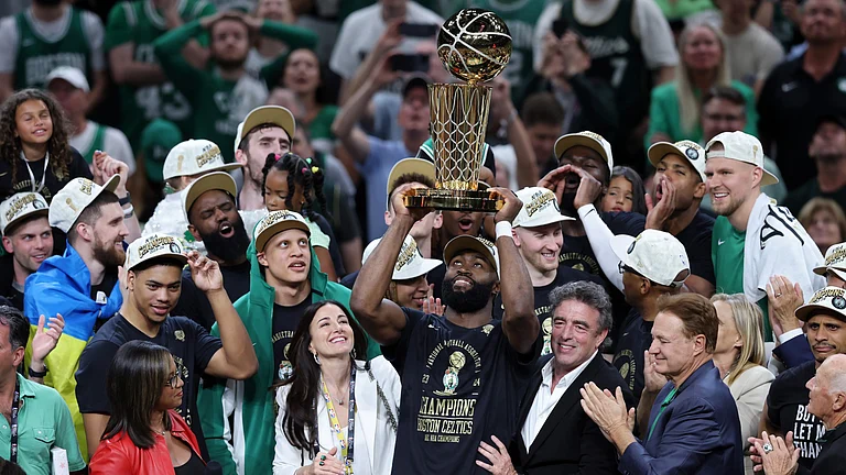 Jaylen Brown hoists the Larry O'Brien Trophy after the Boston Celtics won the 2024 NBA Finals. - null