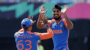 AP/Adam Hunger : India's Arshdeep Singh, right, celebrates with teammate Suryakumar Yadav.