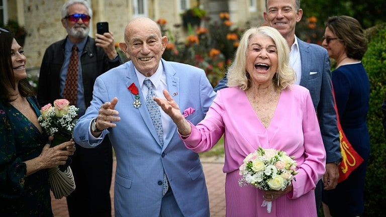 X : 100-year-old WWII veteran Harold Terens and 96-year-old Jeanne Swerlin married in Normandy. 