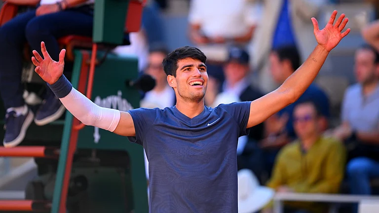 Carlos Alcaraz (21 years and 33 days) is the youngest player in the Open Era to reach the men's singles finals in Grand Slam events on clay, grass and hard court. - null