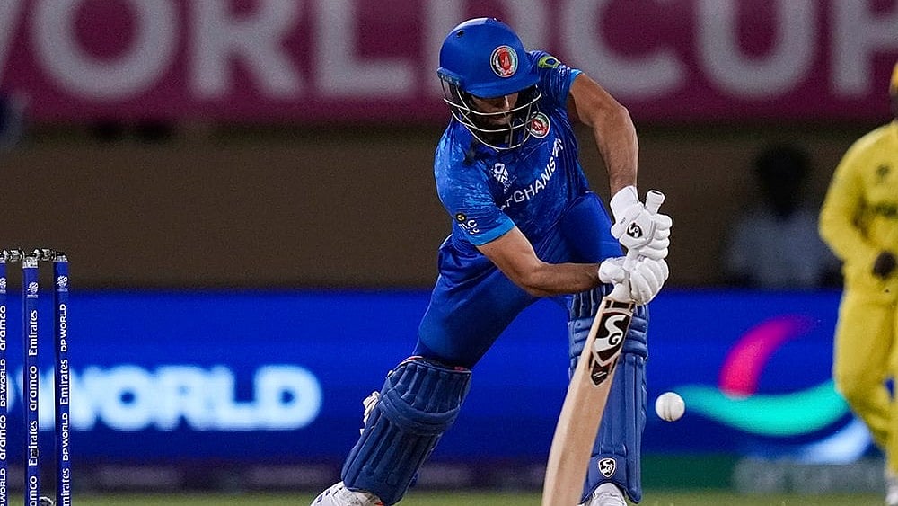 | Photo: AP/Ramon Espinosa : Ibrahim Zadran plays a shot against Uganda