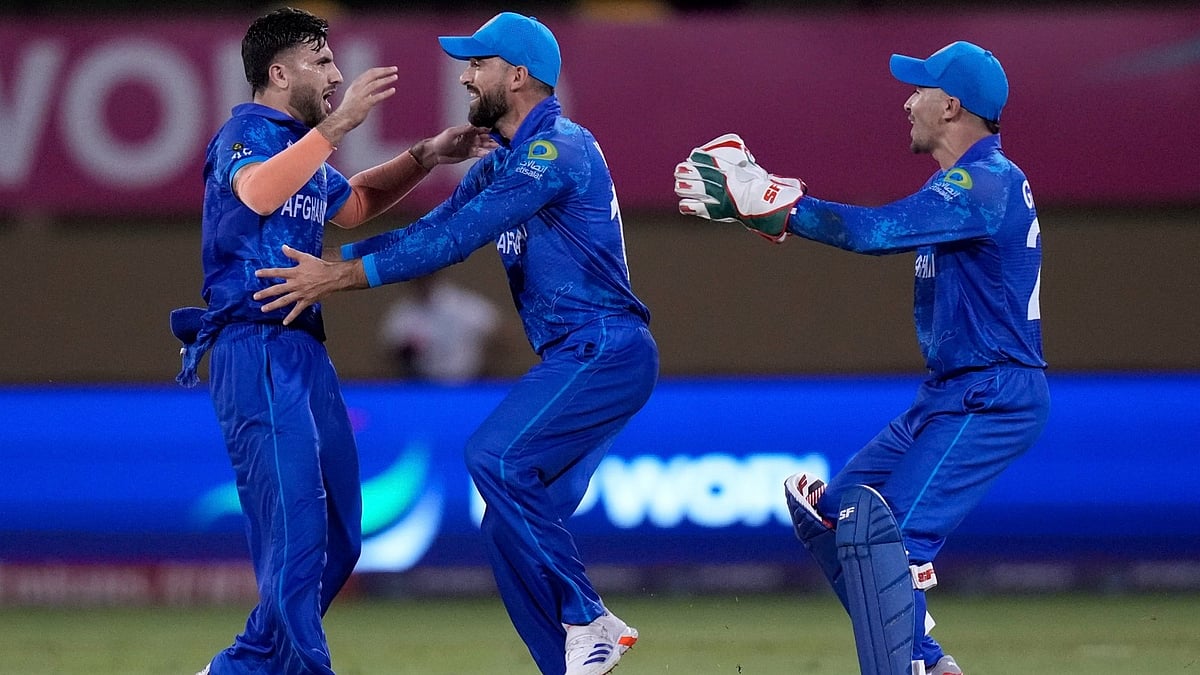 Afghanistan's Fazalhaq Farooqi, left, celebrates the dismissal of New Zealand's Daryl Mitchell during their ICC Men's T20 World Cup  2024 match at Providence Stadium, Guyana on June 7, 2024. - AP/PTI