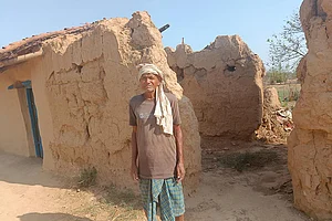 Photo: Md Asghar Khan : Unsung Hero: Laungi Bhuiyan stands outside his dilapidated mud house in Kothilwa village, Gaya district