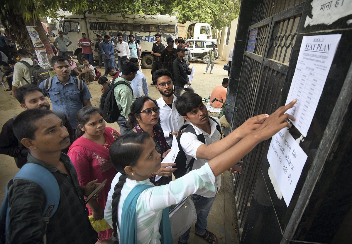 PTI : Aspirants look for their roll numbers before entering an examination centre for the UPSC Civil Services (Preliminary) exam, in Patna, Sunday, June 16, 2024. 