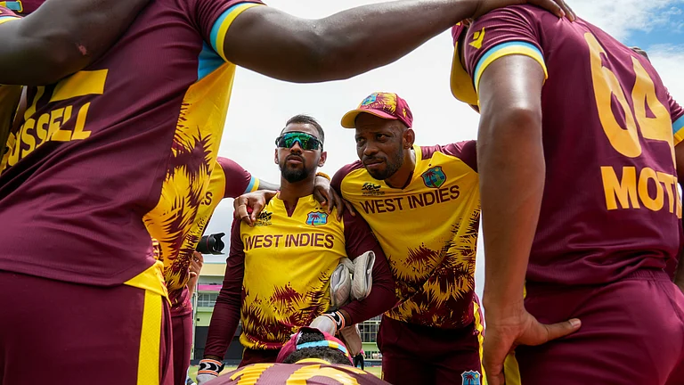 West Indies' Roston Chase, right, gathers with teammates prior to their during an ICC Men's T20 World Cup cricket match against Papua New Guinea at Guyana National Stadium in Providence, Guyana, Sunday, June 2, 2024.
- (AP Photo/Ramon Espinosa)
