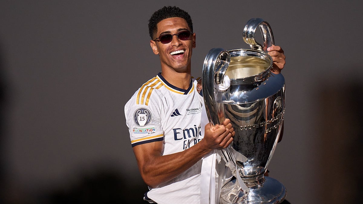 Jude Bellingham celebrates with the Champions League trophy - null