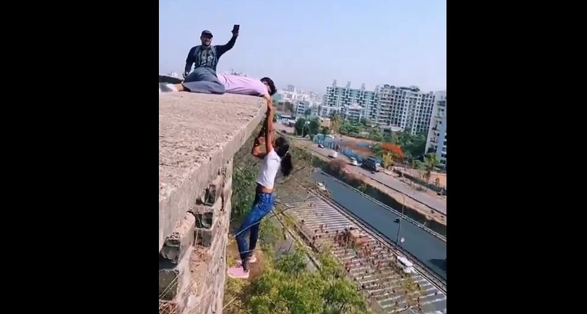 Viral Video | Pune Woman Hangs From Building Roof Holding Man's Hand Without Safety Measures For A Reel