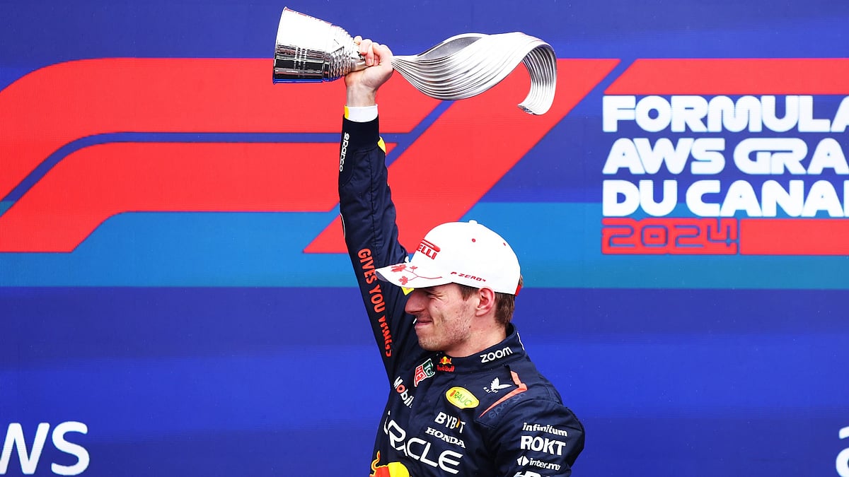 Max Verstappen holds the Canadian Grand Prix trophy aloft