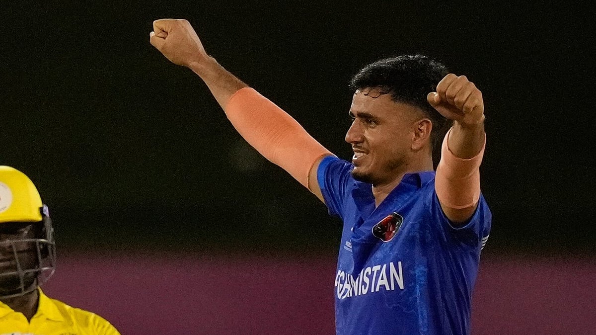 Afghanistan's Mujeeb Ur Rahman, right, celebrates after his team beat Uganda for 125 runs during an ICC Men's T20 World Cup cricket match at Guyana National Stadium in Providence, Guyana, Monday, June 3, 2024.

 -  (AP Photo/Ramon Espinosa)
