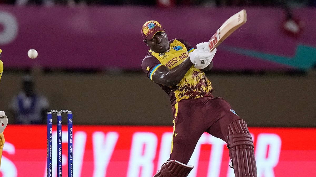 West Indies captain Rovman Powell plays a shot to be caught by Uganda's Robinson Obuya for 23 runs during an ICC Men's T20 World Cup cricket match at Guyana National Stadium in Providence, Guyana. - AP Photo/Ramon Espinosa