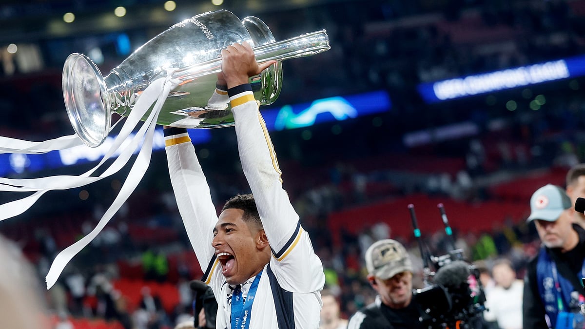 Jude Bellingham holds the Champions League trophy aloft. - null