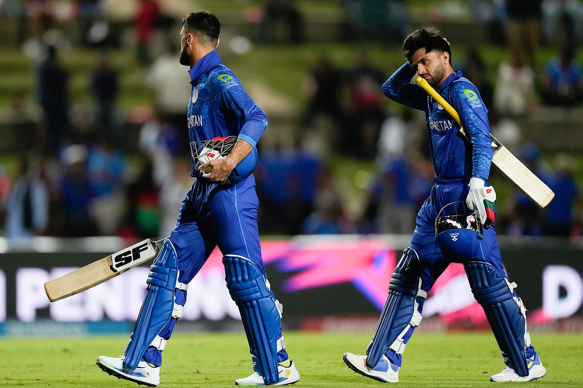 (AP Photo/Ricardo Mazalan) : Afghanistan's Naveen-ul-Haq an teammate Fazalhaq Farooqi walk from the field after they were dismissed for 56 runs during the men's T20 World Cup semifinal cricket match between Afghanistan and South Africa at the Brian Lara Cricket Academy in Tarouba, Trinidad and Tabago, Wednesday, June 26, 2024. 