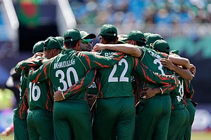 (AP Photo/Adam Hunger) : Bangladesh players huddle before the start of the ICC Men's T20 World Cup cricket match between Bangladesh and South Africa at the Nassau County International Cricket Stadium in Westbury, New York, Monday, June 10, 2024.