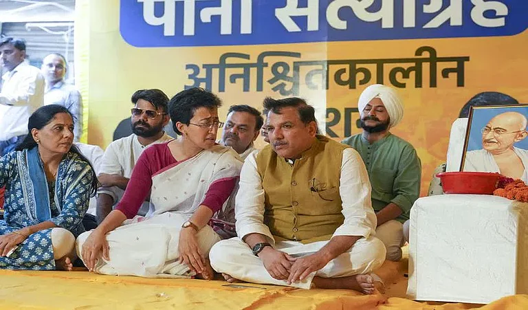 Delhi Water Minister Atishi with Sunita Kejriwal and AAP leader Sanjay Singh | - PTI