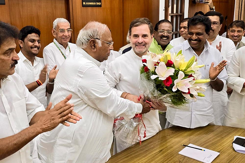 Photo: PTI : Mallikarjun Kharge greets Rahul Gandhi