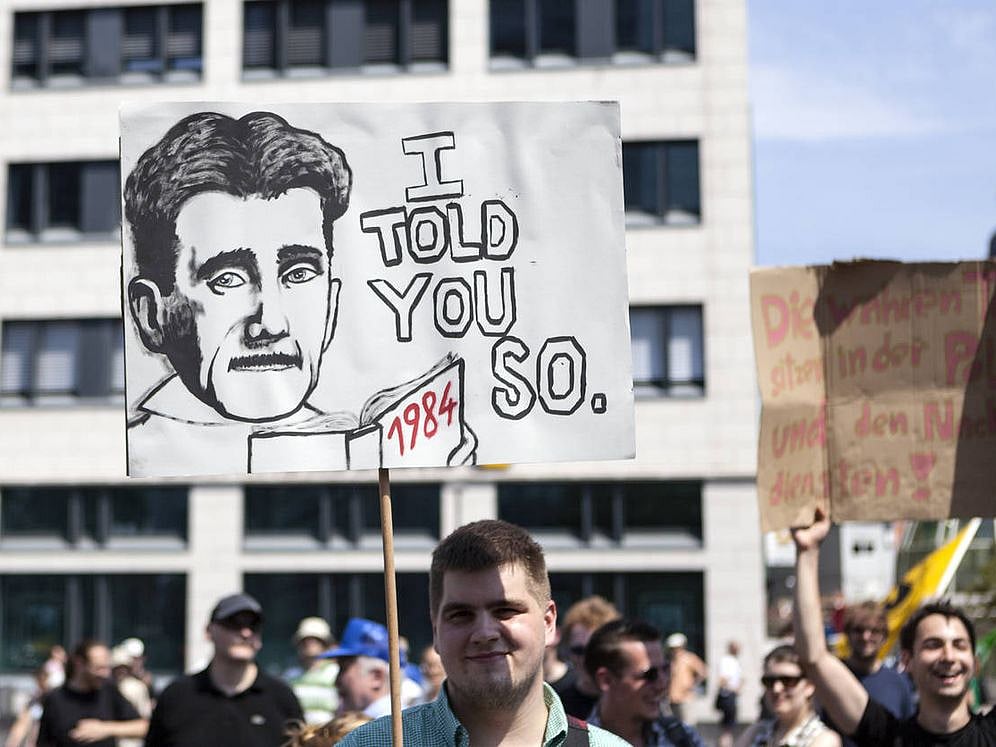 Protestor holding up a banner during a demonstration in the city center of Frankfurt, Germany.  - Photo via Getty
