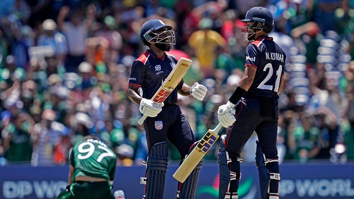 Photo: AP/PTI : Pakistan's Haris Rauf, left, on the ground, reacts as United States' Aaron Jones and Nitish Kumar, right, celebrate during the ICC Men's T20 World Cup cricket match between the United States and Pakistan at the Grand Prairie Stadium in Texas.