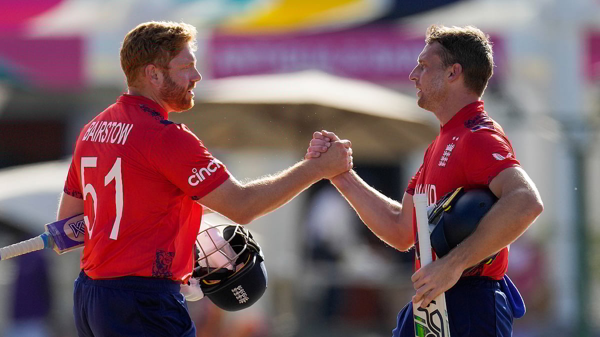England's captain Jos Buttler, right, and batting partner Jonny Bairstow shake hands at the end of the ICC Men's T20 World Cup cricket match against Oman at Sir Vivian Richards Stadium in North Sound, Antigua and Barbuda, Thursday, June 13, 2024. England won by eight wickets with 101 balls remaining. 

 - (AP Photo/Ricardo Mazalan)
