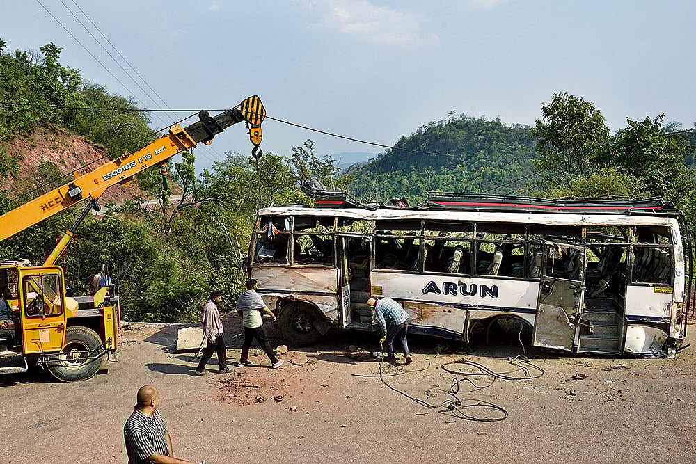 The Wreckage: The damaged bus being towed away from the site of the June 9 attack in Reasi - Photos: Yasir Iqbal