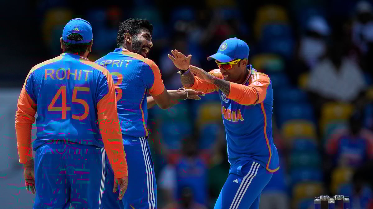 bumrah, sky and rohit celebrating a wicket. AP Photo