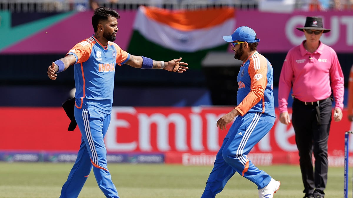 Photo: AP/PTI : India's Hardik Pandya, left, celebrates with captain Rohit Sharma.