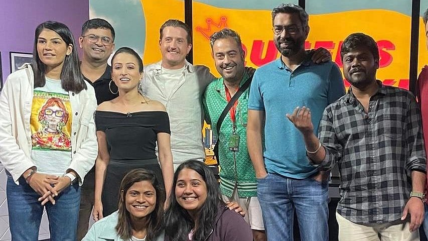 Indian women's cricket team player Radha Yadav (1st from lower left) posing for a photo with Marc Hayward (M) and others. - Special Arrangement