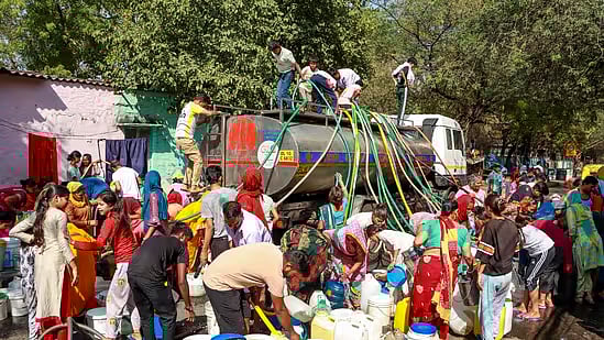PTI : Water being distributed from a tanker in Delhi |