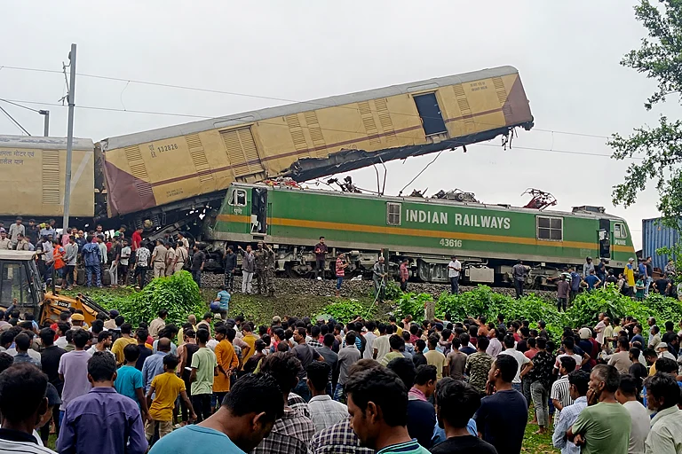 Onlookers watch as rescuers work after a cargo train rammed into Kanchanjunga Express, a passenger train, near New Jalpaiguri station, West Bengal state, India, Monday, June 17, 2024 - AP