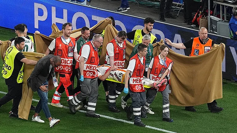 Barnabas Varga is carted off the pitch after an injury - | Photo: AP/Ariel Schalit