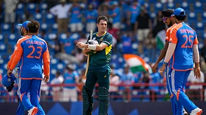 AP Photo/Ramon Espinosa : Australia's Pat Cummins stands of the field after his side lost by 24 runs against India in an ICC Men's T20 World Cup cricket match at Darren Sammy National Cricket Stadium in Gros Islet, Saint Lucia.