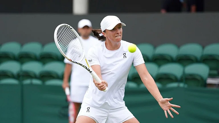 Poland's Iga Swiatek plays a volley on the practice court at the All England Lawn Tennis and Croquet Club ahead of the Wimbledon Championships, which begins on July 1st, in London, Friday June 28, 2024. - PA via AP/Zac Goodwin