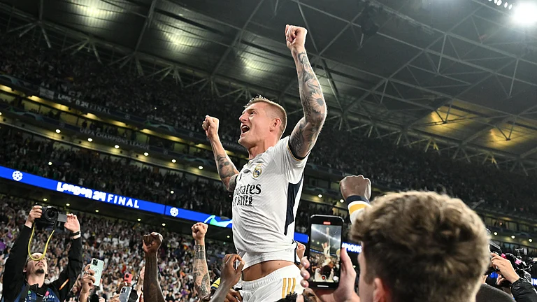 Toni Kroos is hoisted in front of Real Madrid supporters after Saturday's Champions League heroics - null