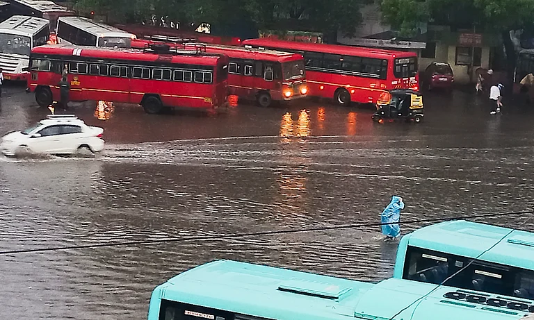 Pune: Commuters wade through a waterlogged road amid rains, in Pune, Saturday, June 8, 2024.  - PTI