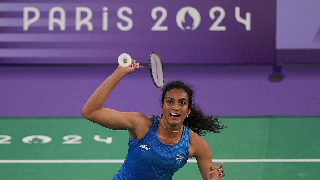 AP/Kin Cheung : India's Pusarla V. Sindhu plays against Estonia's Kristin Kuuba during their women's singles badminton group stage match.