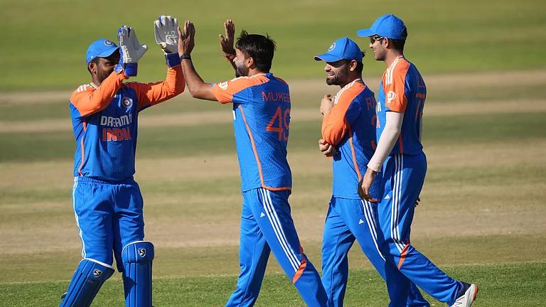 Indian players celebrate a wicket during the T20 cricket match between Zimbabwe and India at the Harare Sports Club, in Harare. - AP Photo/Tsvangirayi Mukwazhi
