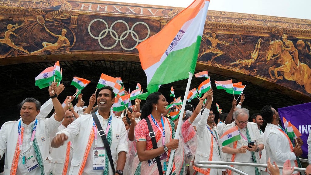 X/@Olympics : Indian flagbearers Achanta Sharath Kamal and PV Sindhu at the 2024 Paris Olympic Games Opening Ceremony