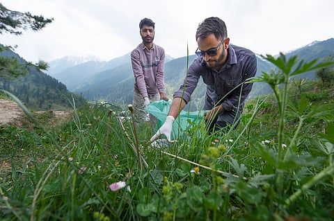 Volunteers collecting trash in Aru Valley, Pahalgam