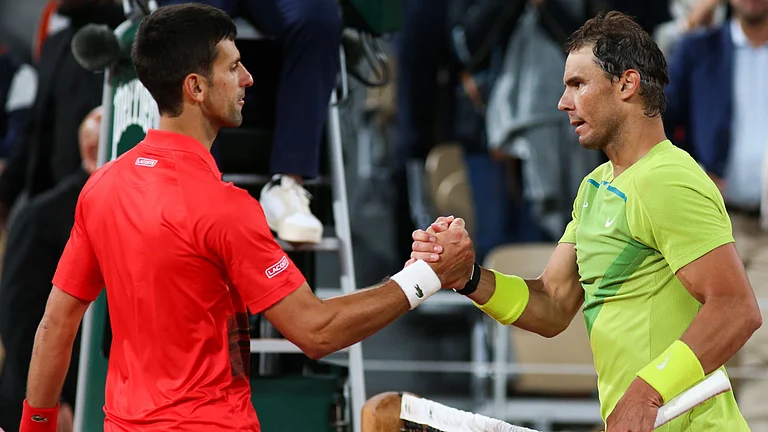 Nadal (right) and Djokovic will do battle once more at Roland-Garros - null