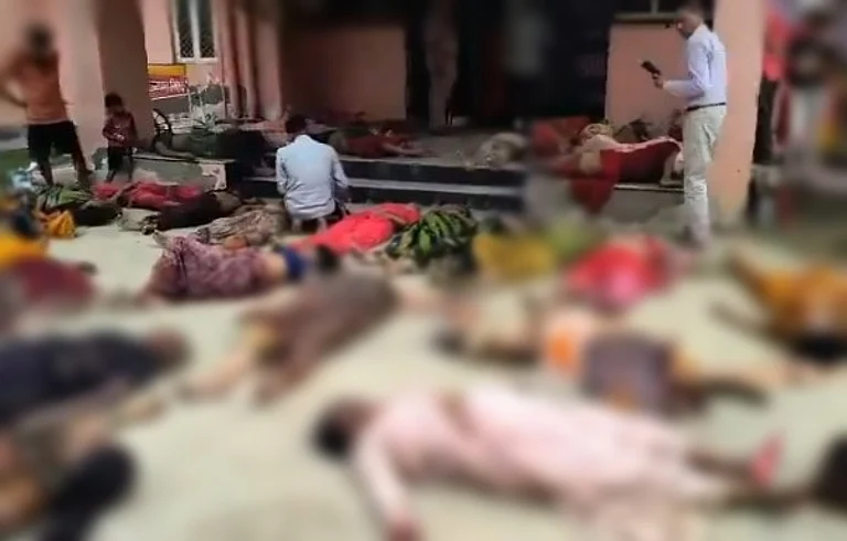Heart-wrenching videos showed bodies of women who died in the Hathras stampede kept on floor of what appeared to be a medical facility.
- null
