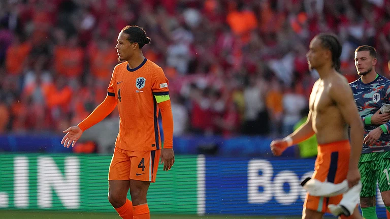 Virgil van Dijk of the Netherlands (4) and teammates walk off the field following a Group D match against Austria at the Euro 2024 soccer tournament in Berlin, Germany. - AP Photo/Sunday Alamba
